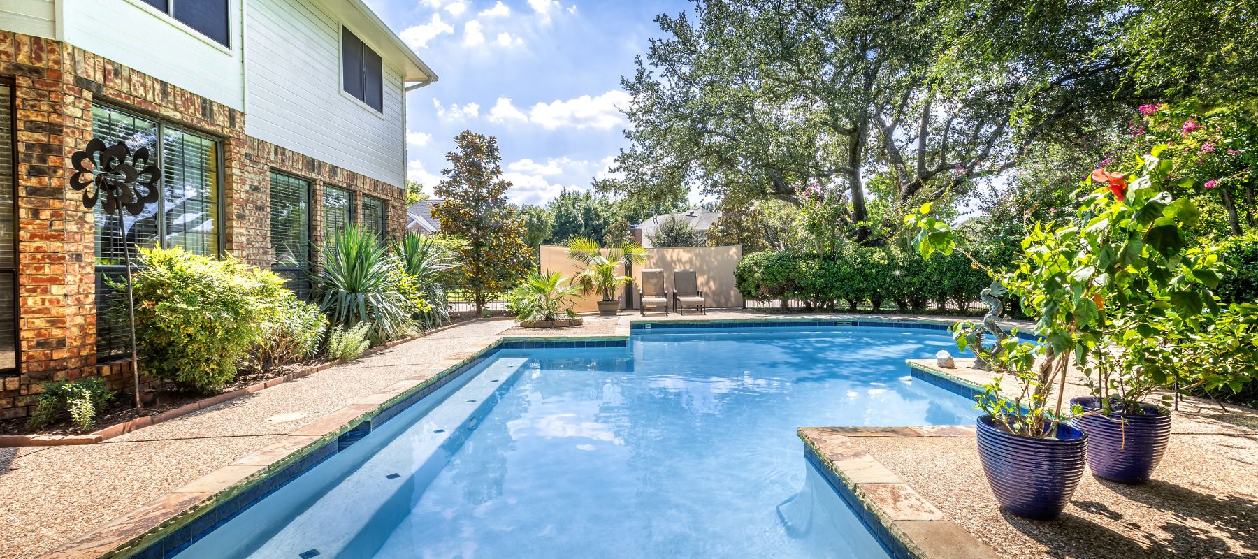 rectangular pool with bright flowers next to it