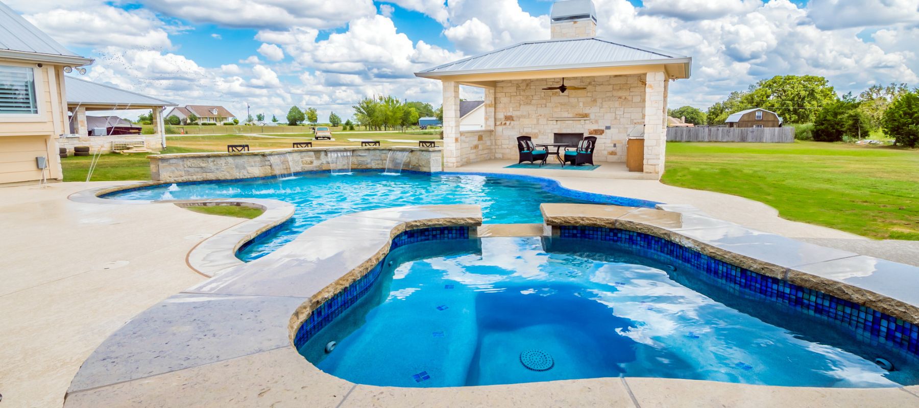 pool with a patio portion in the backyard