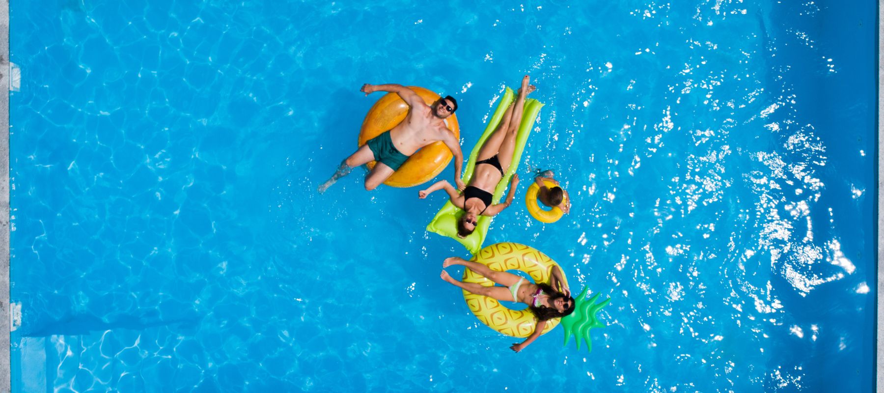 people sitting on floats enjoy the summer weather